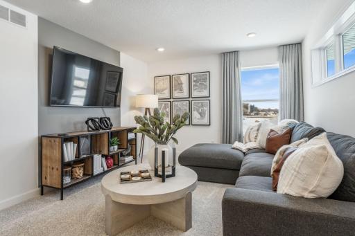 Located on the upper level, this perfectly sized living space has enough room for a desk, television and seating for all. Plus, it is just steps away from all four upper level bedrooms. (Photo is of the actual home.)