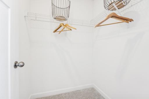The primary bedroom features an incredible walk-in closet. (Photo is of the actual home.)