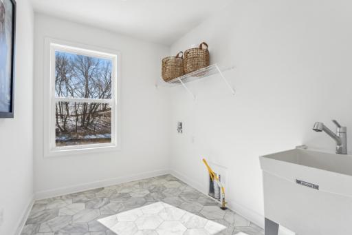 Convenient upper level laundry. (Photo is of the actual home.)