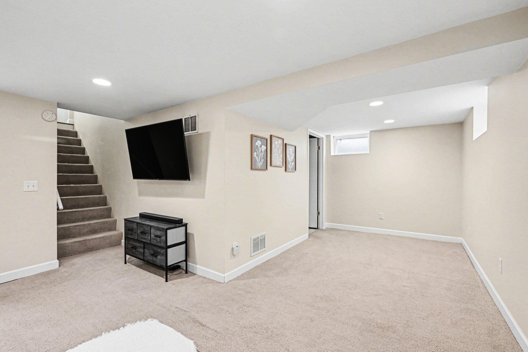Lower level living room with adjoining bonus space. Perfect for a bar, gym, additional seating and endless opportunities