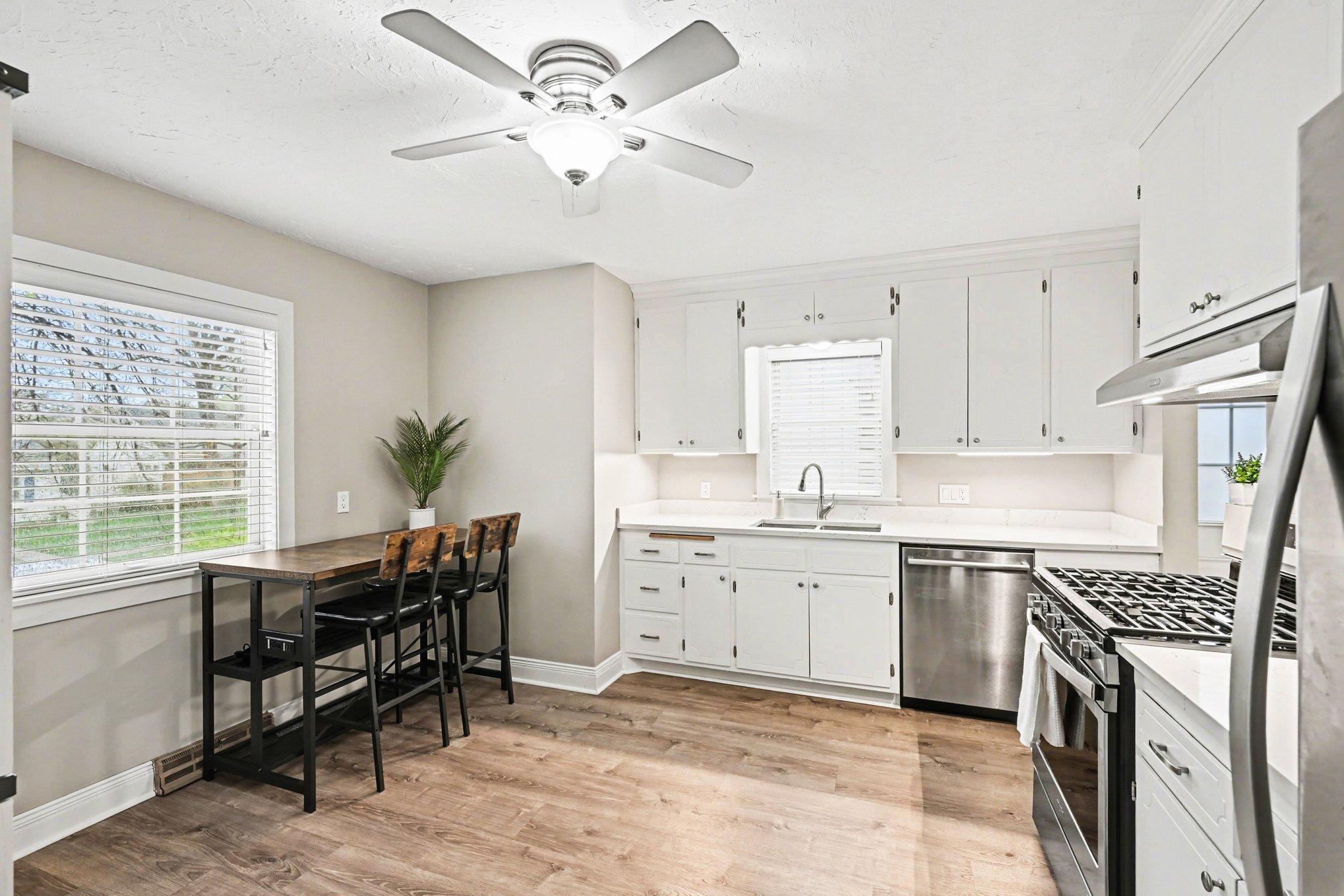 Large kitchen with eat-in dining and stainless steel appliances throughout