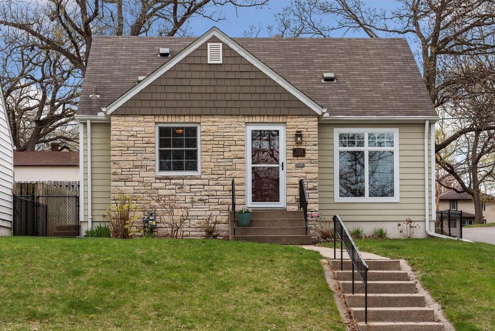 Lovely corner lot with brick and shakes exterior provides the ultimate curb appeal