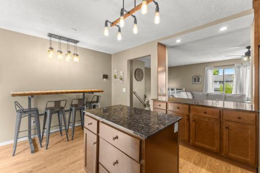 Granite countertops, kitchen island, and dining space.
