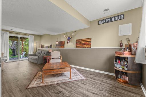 Spacious walkout lower level family room with tons of natural lighting.