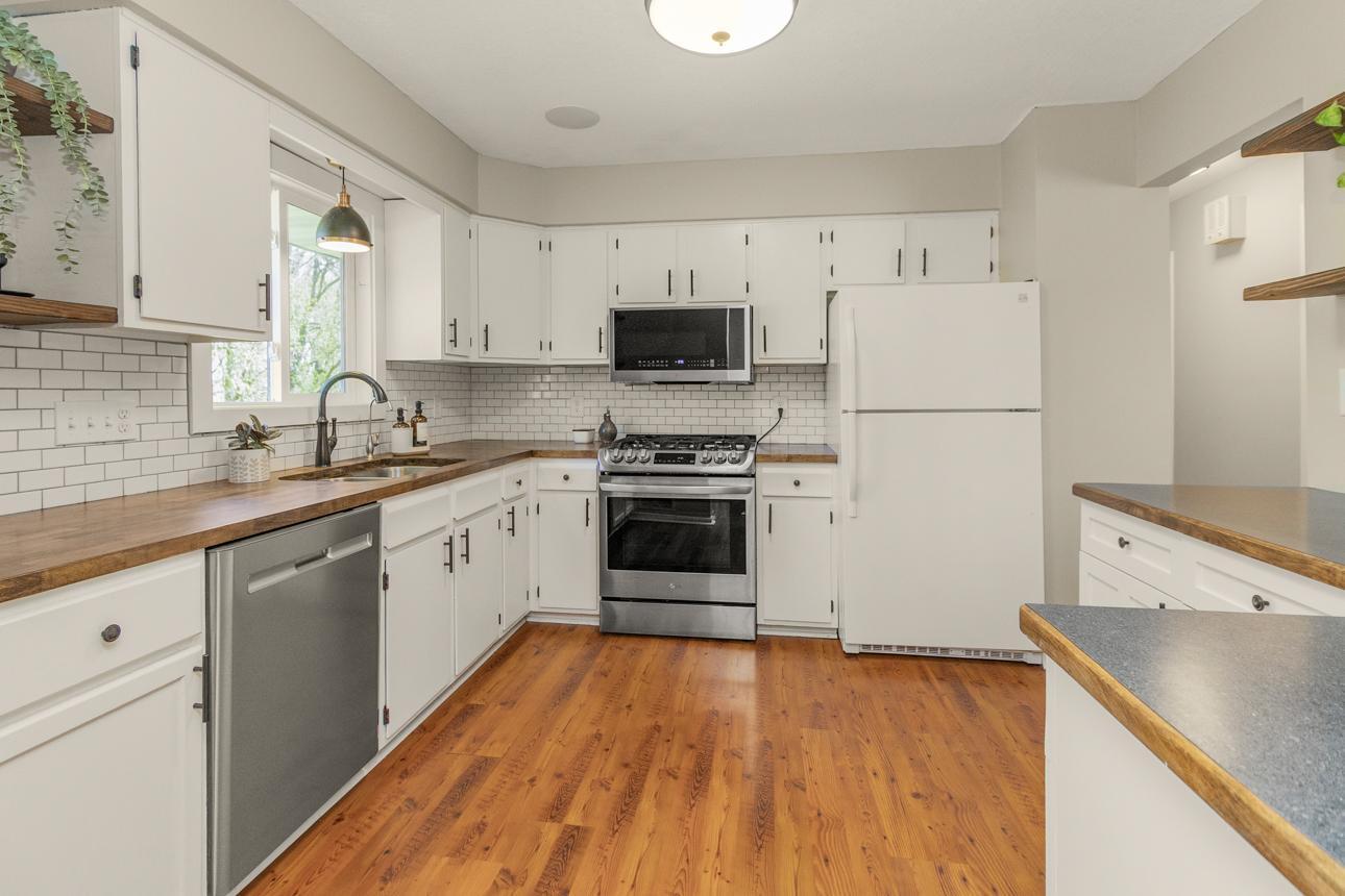 Kitchen with newer gas stove and microwave