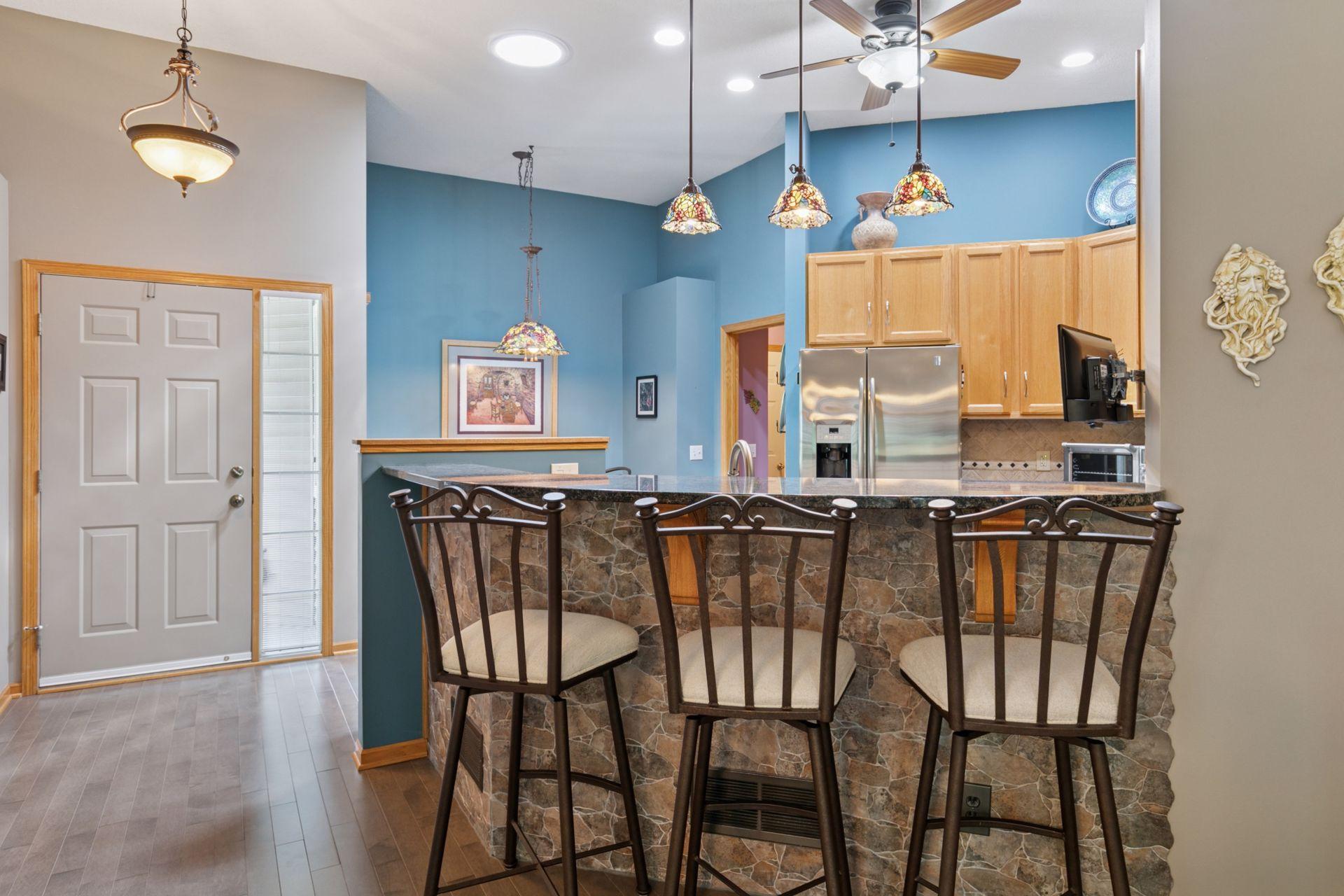 Check out the high ceiling, fan, solar tube, recessed and pendant lighting! Here is an example of some fine stone work at the peninsula bar.