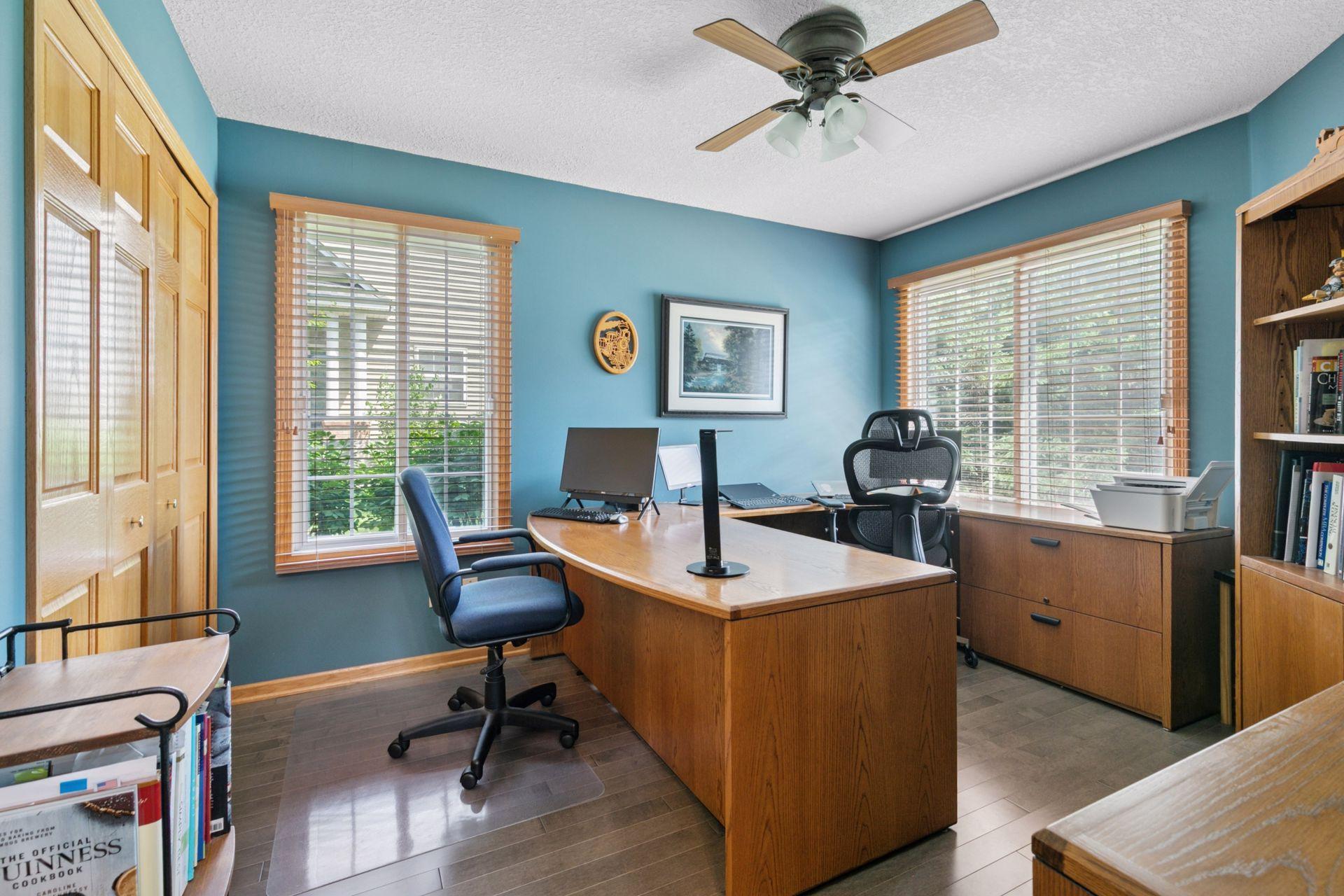 Behind door #1- This is a true bedroom with a closet and TWO banks of windows. But how convenient to have a home office right at your front door. Check out the wood floors that flow from the kitchen into this room.