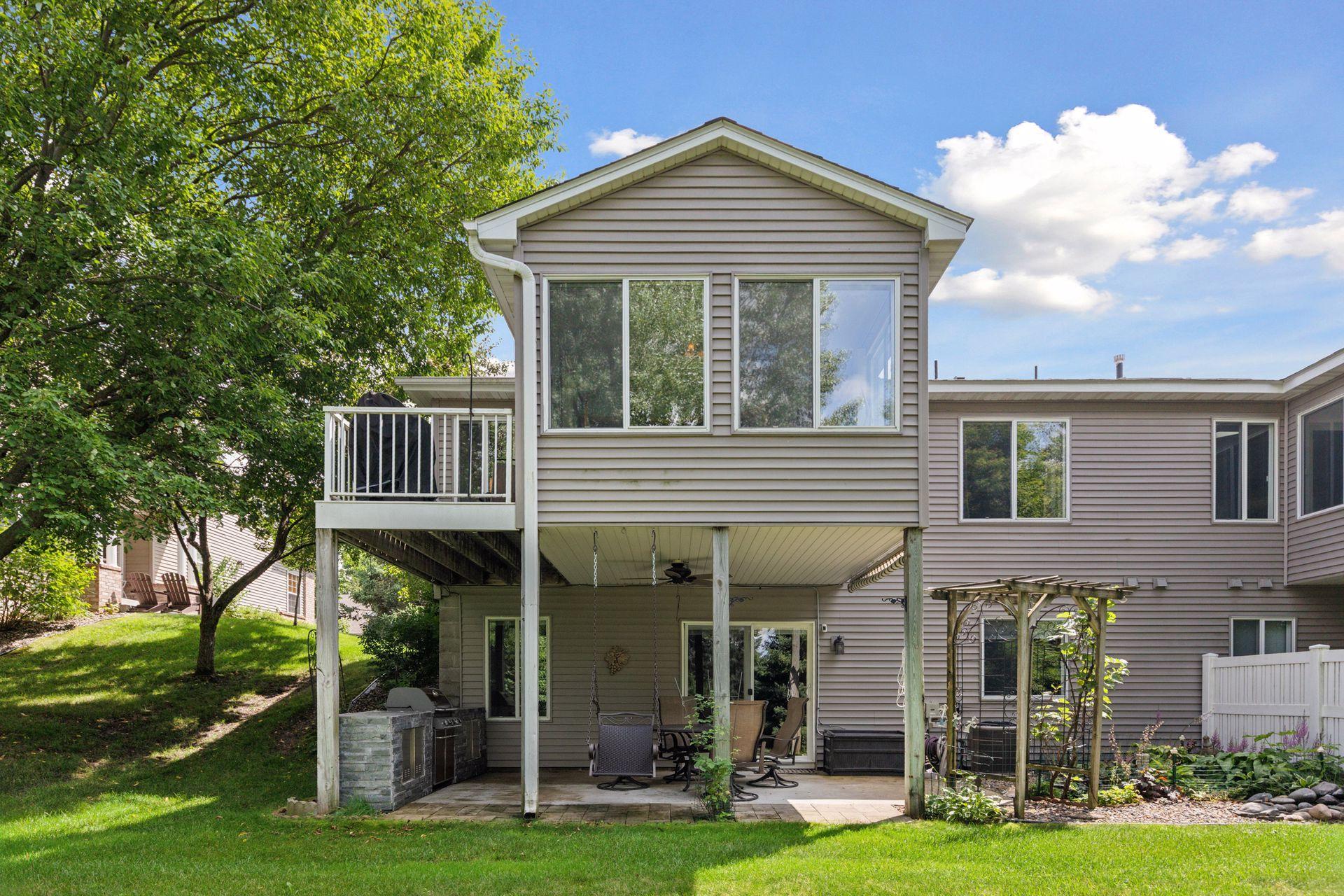 The exterior of the home/porch. Note the distance and trees from the neighbor on the left.