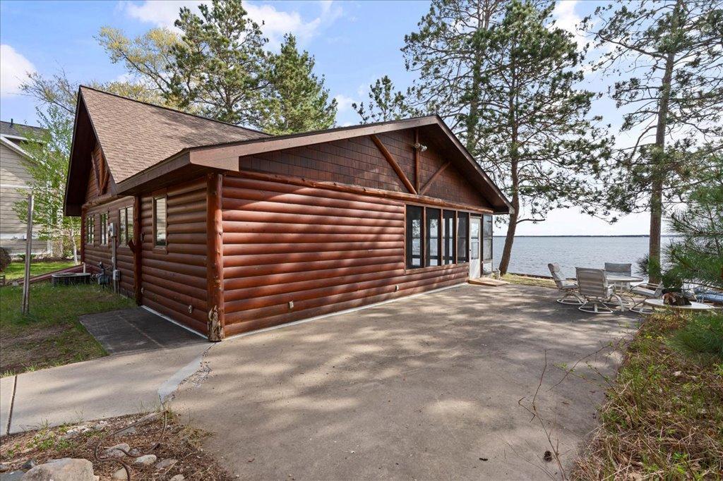 Lakeside patio area with easy water access and space for outdoor entertaining.
