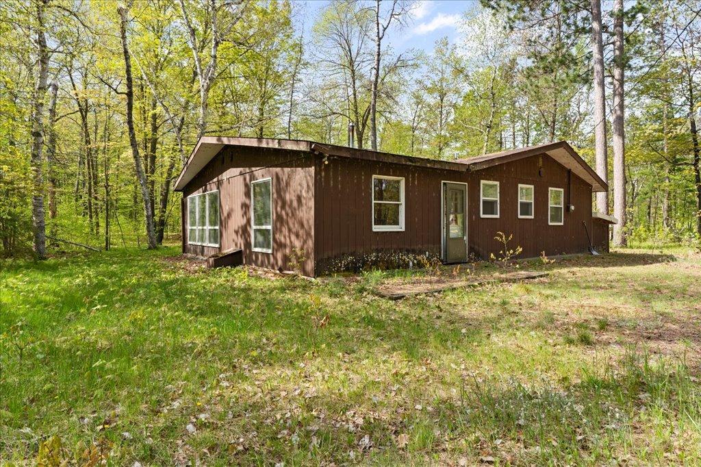 Rustic cabin on its own septic system, offering future remodeling potential for added guest space.