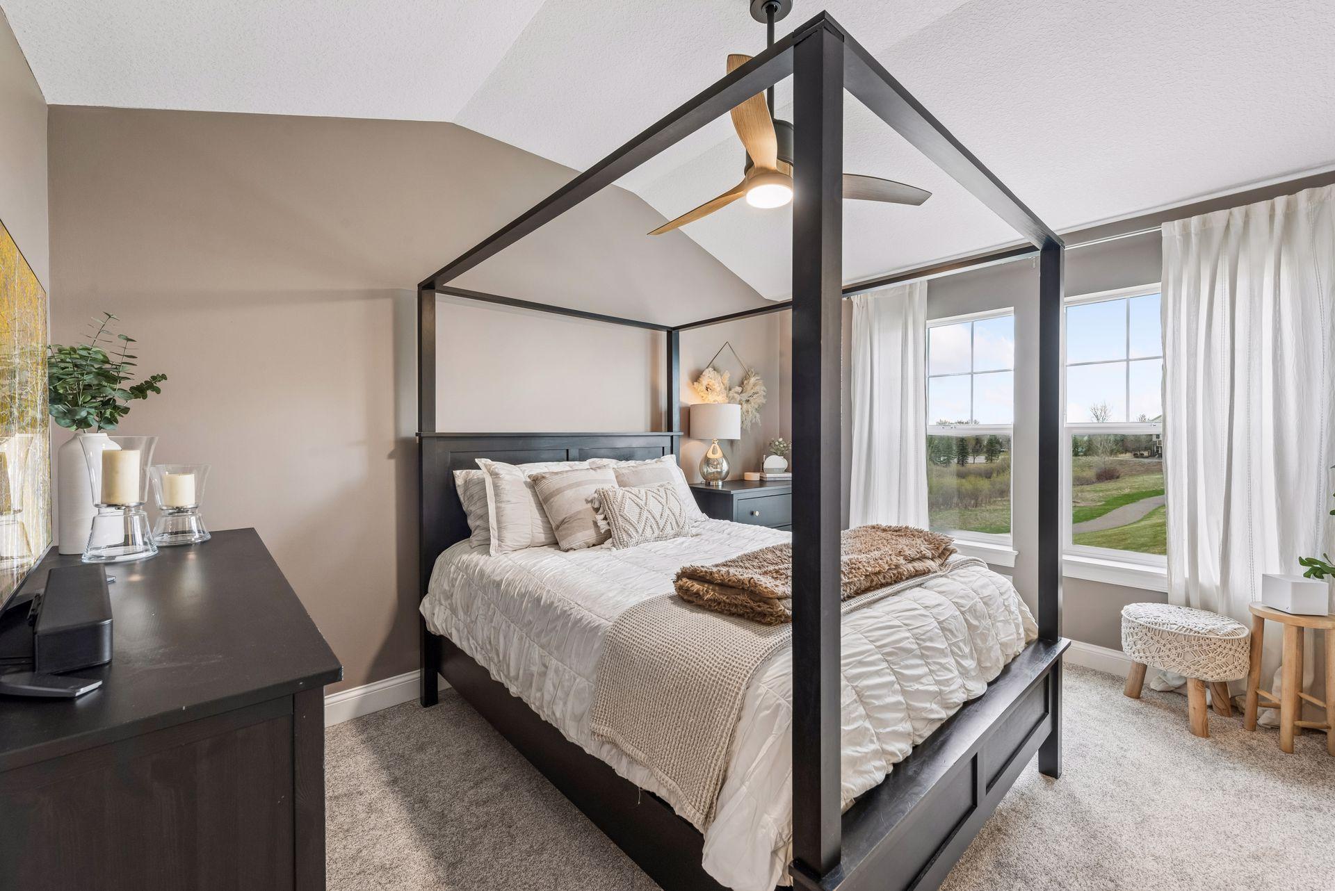 Primary bedroom with vaulted ceilings