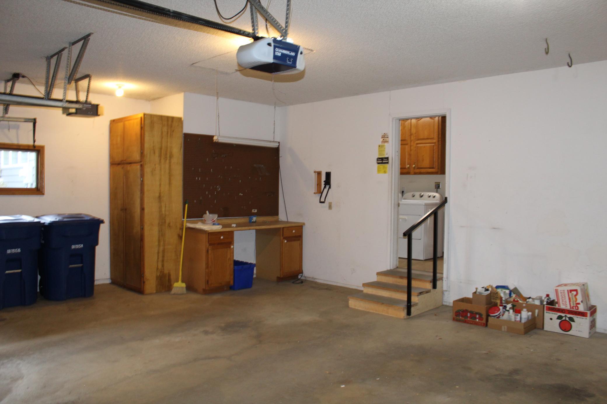2 car garage area with additional golf cart space with opener