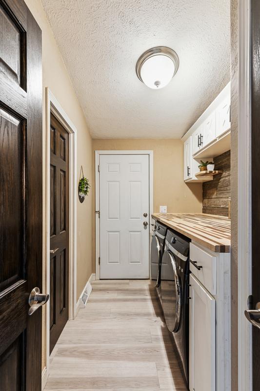 Conveniently, the attached garage opens up to the main floor laundry area, which also has access to the walk-through main floor full bathroom