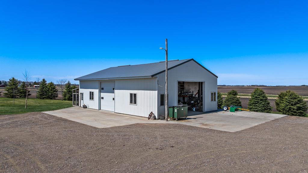 36'x52' Steel pole shed with 2 overhead doors, concrete flooring, floor drains, and utilities already in place with water and LP.