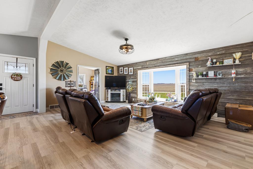 Step inside the front door to an open living, dining, and kitchen