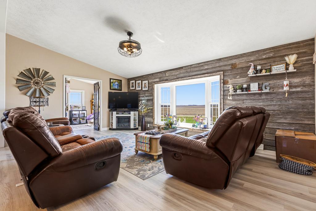 A cozy living room awaits with views to the large open front yard
