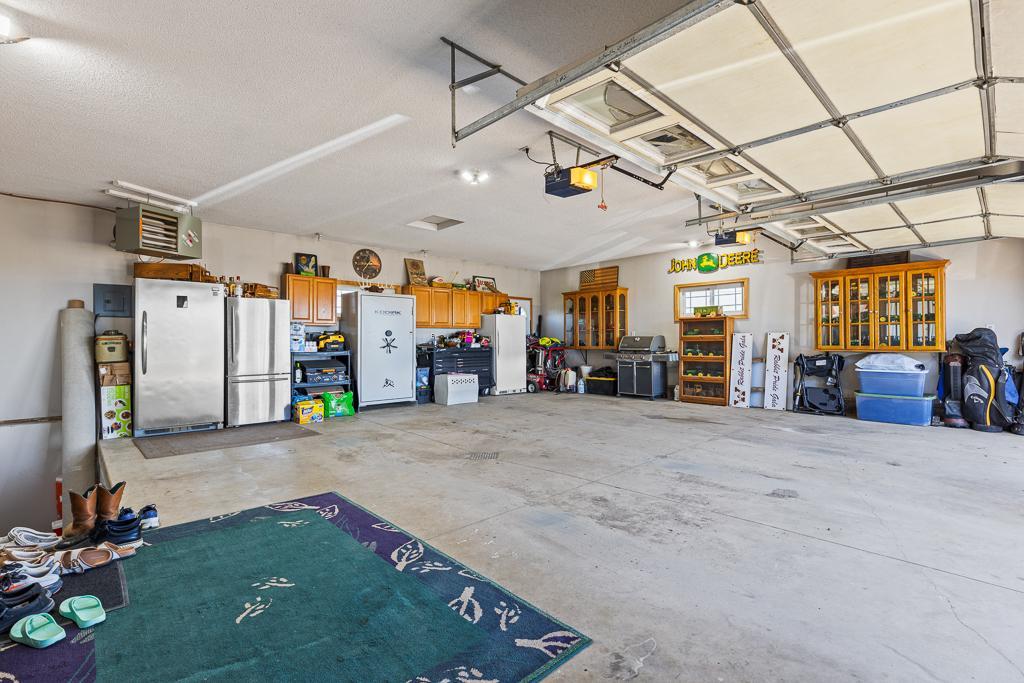 Oversized 2-stall garage with concrete flooring and floor drain