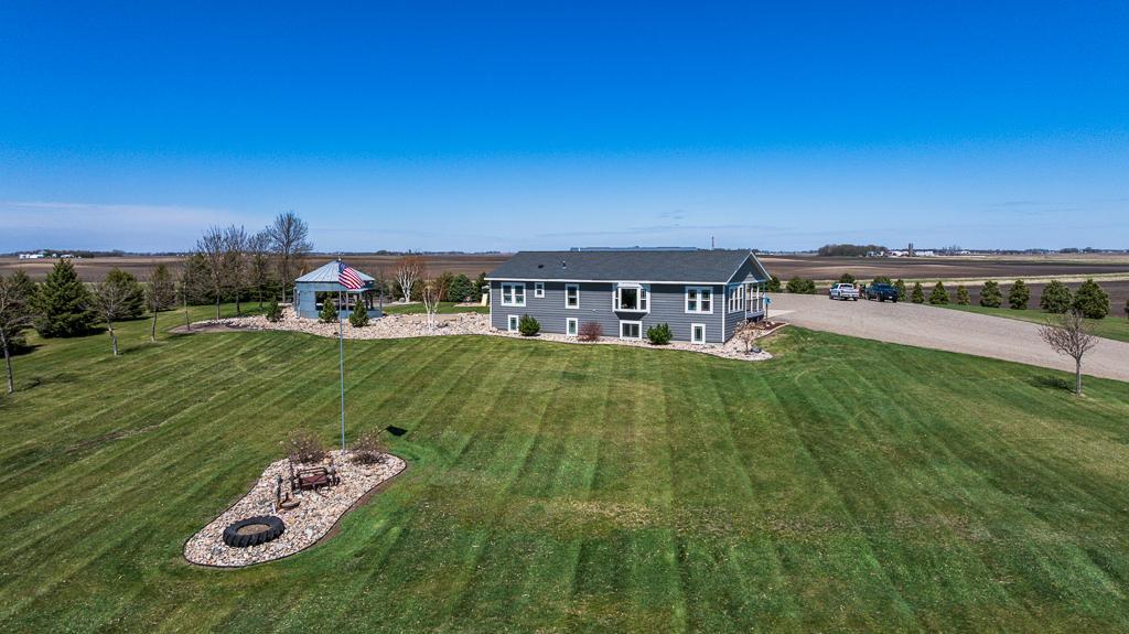 Several landscaped areas surround the home and throughout the property.