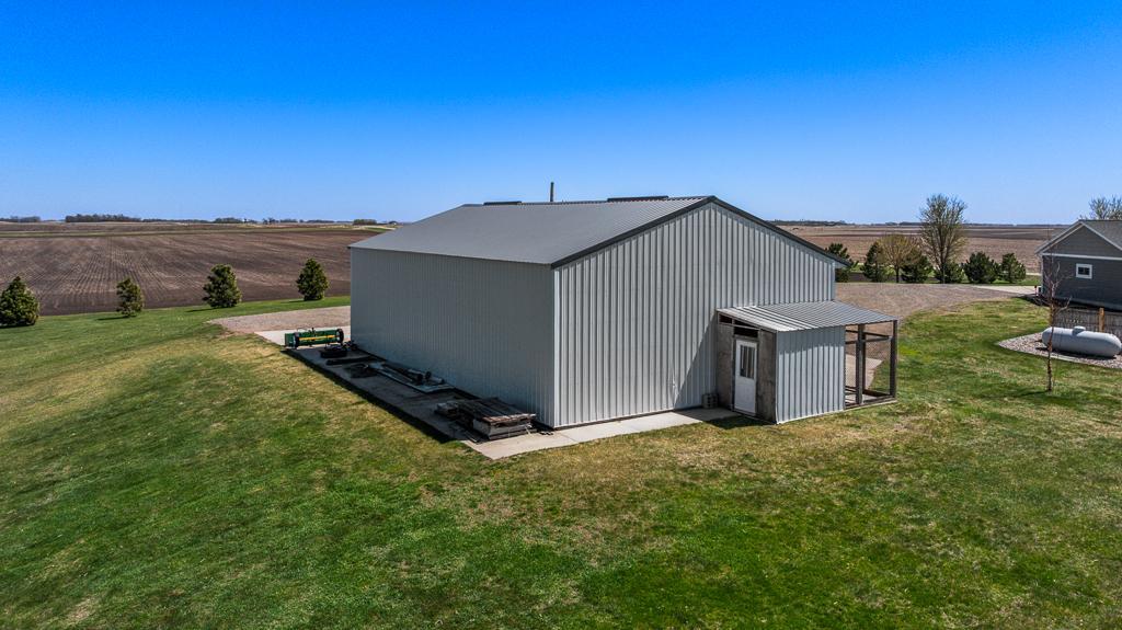 Back of the pole shed shows concrete extending around the building
