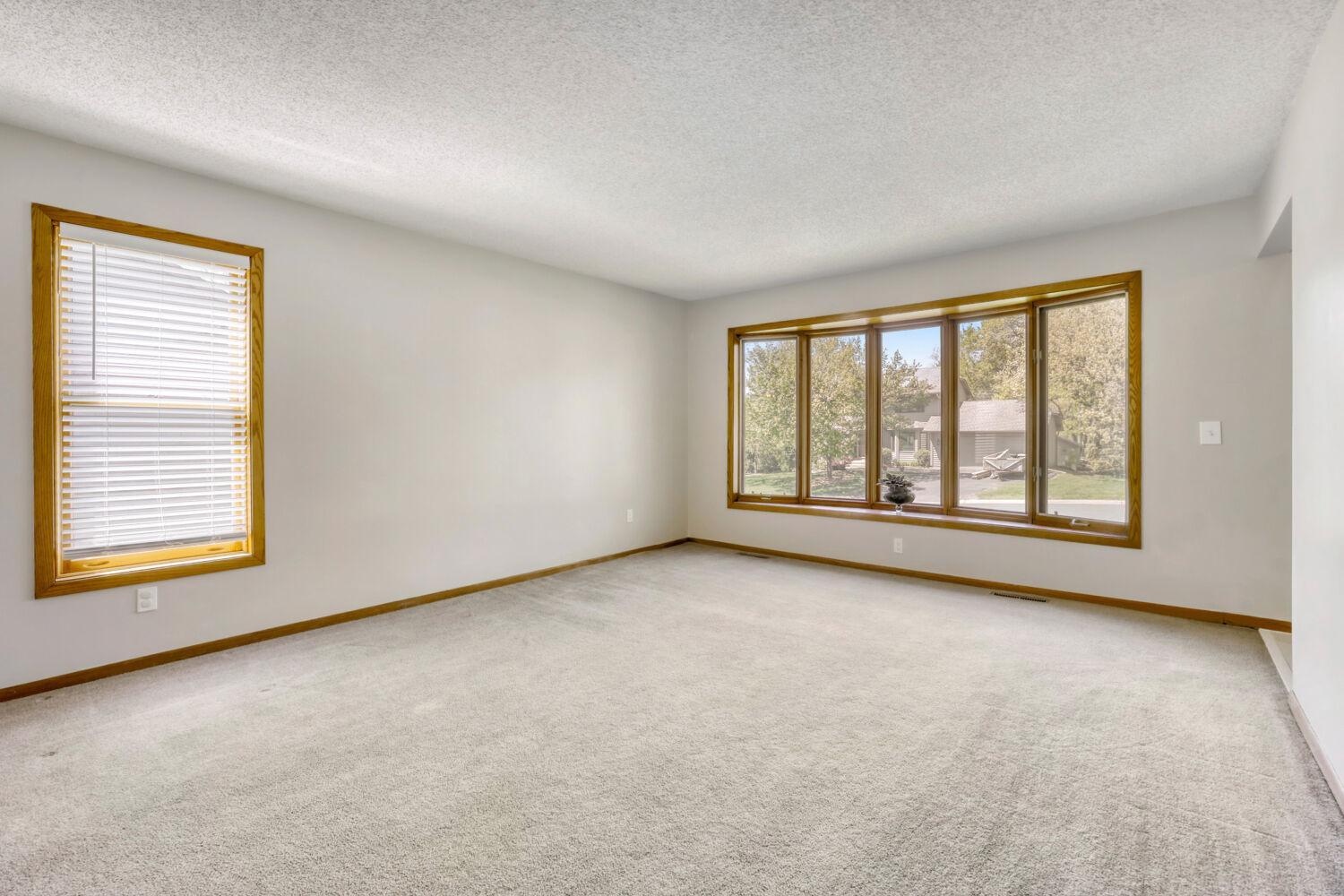 Living room bay windows let all the light into this space providing a nice warm glow