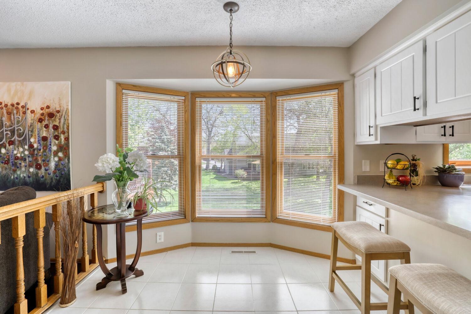 An adorable breakfast nook that overlooks the lush backyard