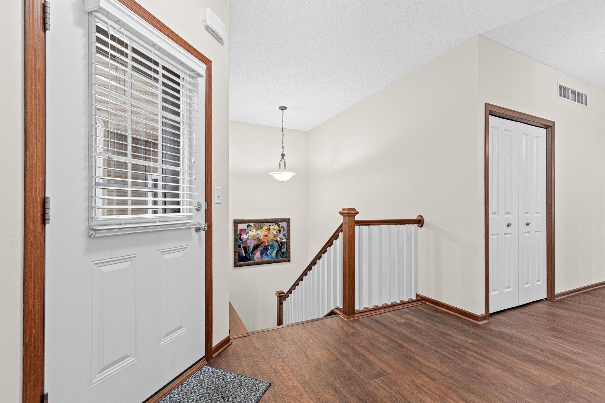 A bright foyer with coat closet creates an inviting entry with neutral tones ready for your personal decorating style.
