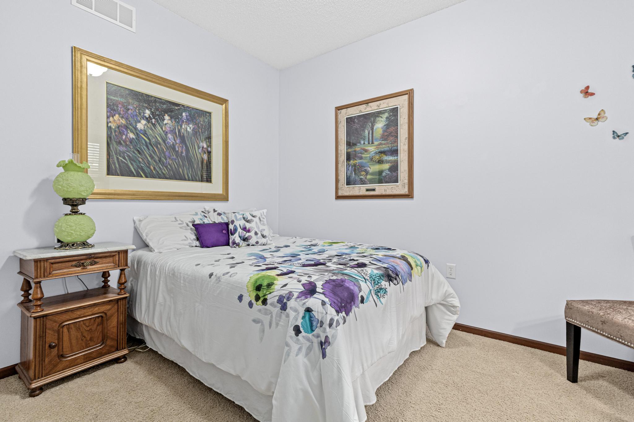 Located at the front of the home, the second bedroom includes overhead lighting and flexible space for residents and guests.