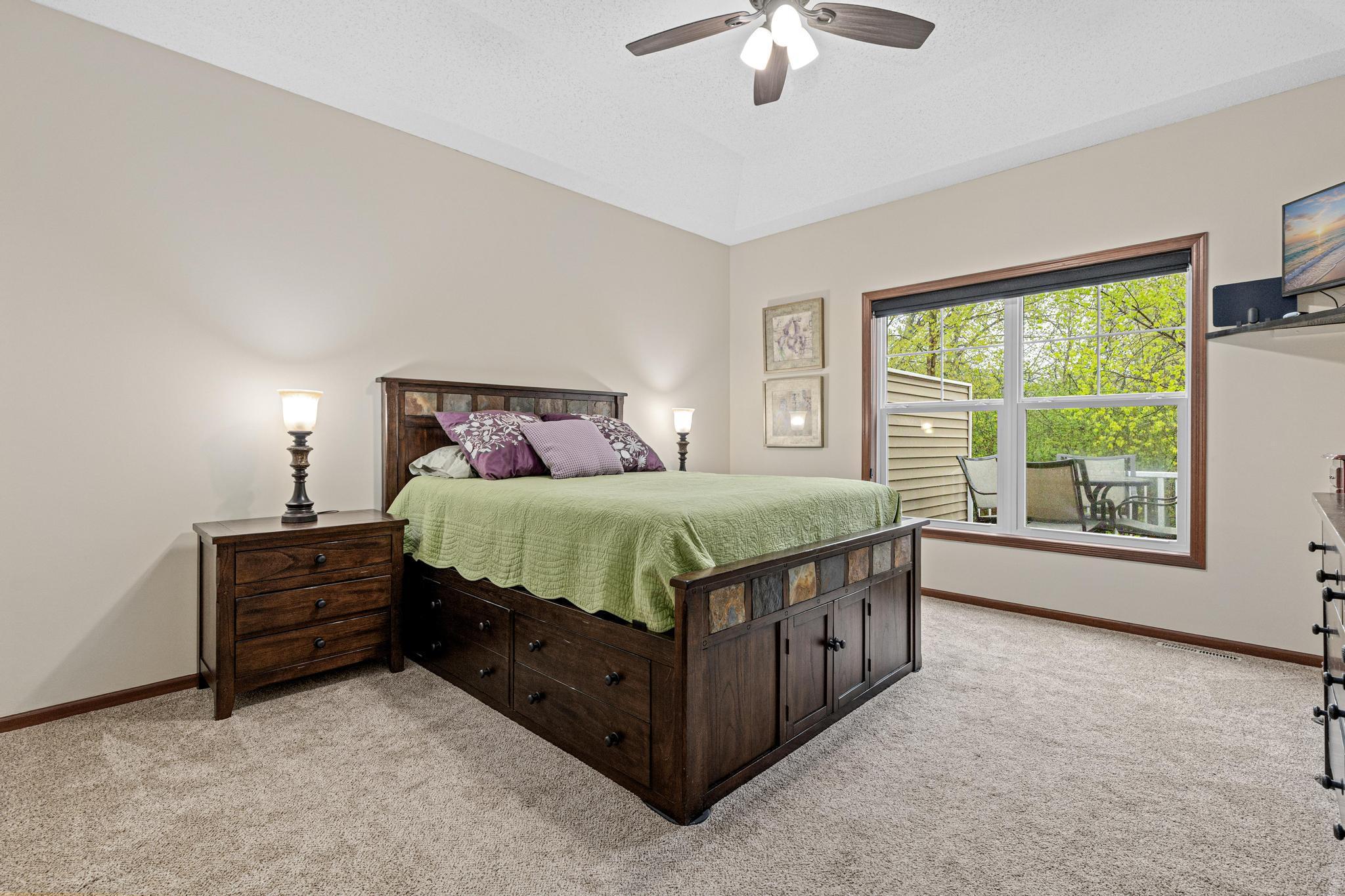The spacious main bedroom suite easily accommodates larger furnishings, offering a restful retreat at day’s end. Blackout blinds, a ceiling fan, and vaulted ceiling add to the character and comfort.