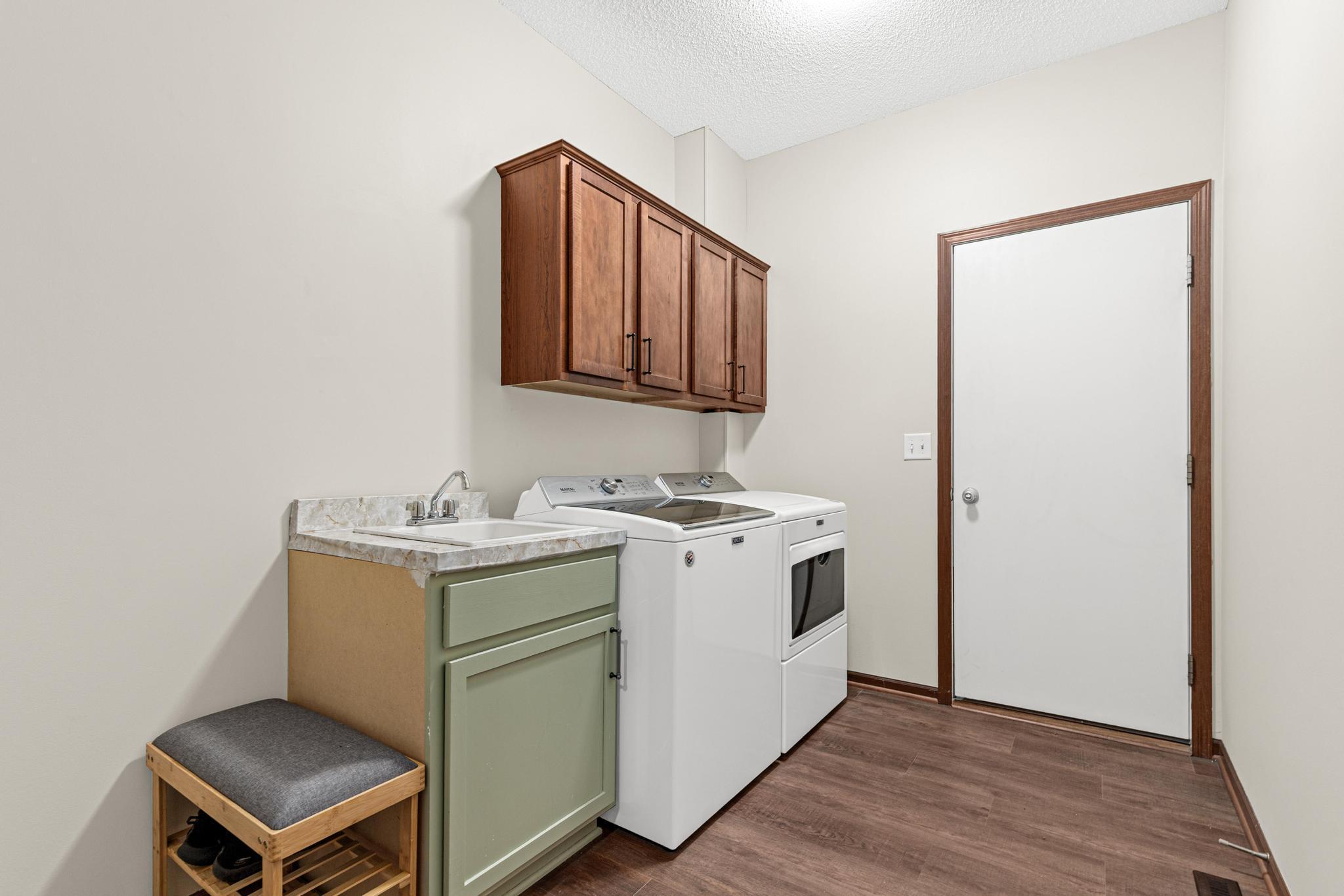 The laundry room provides access to the garage and doubles as a mudroom, complete with drop-down drying racks.