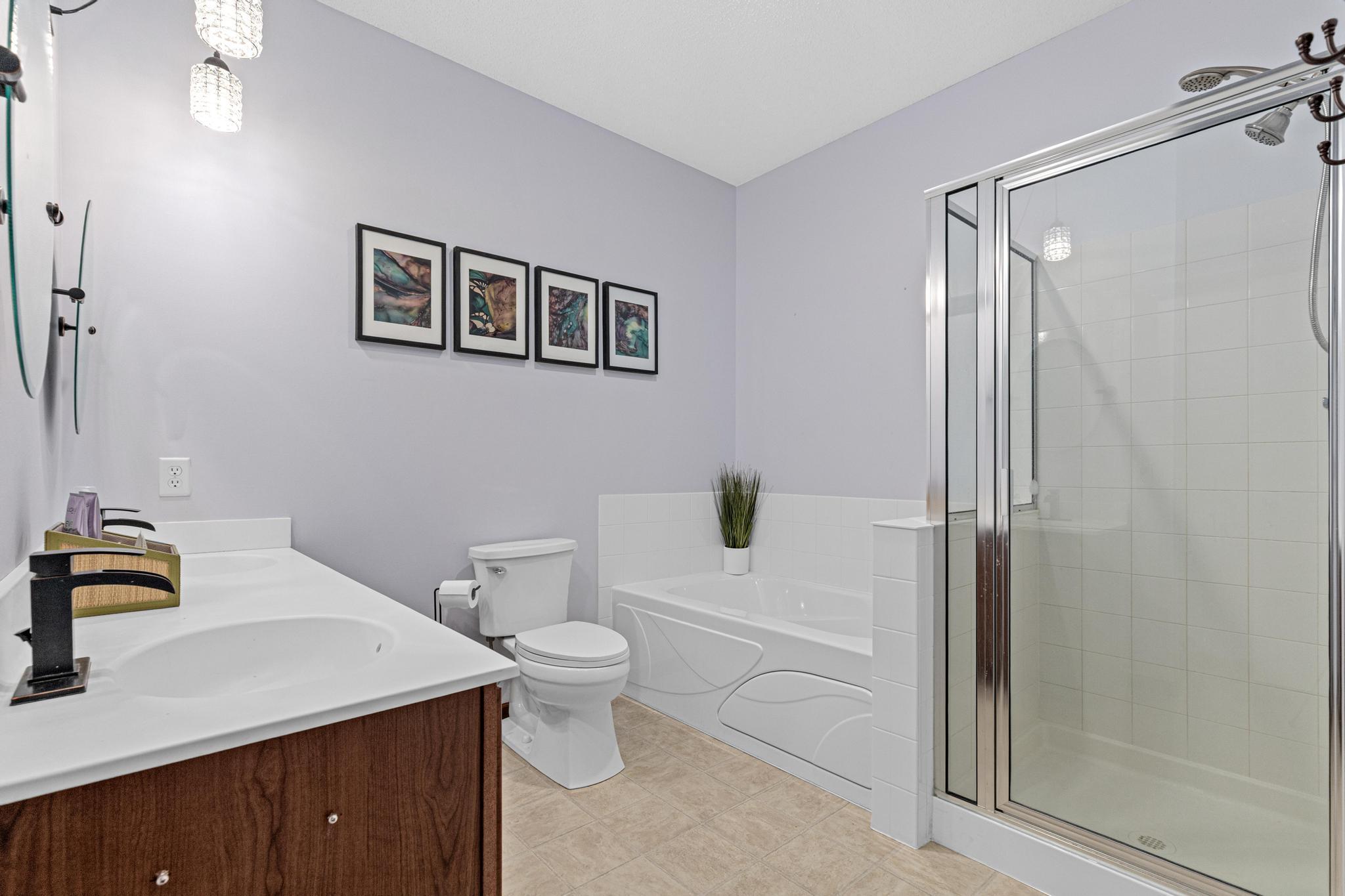 A private ensuite bath offers double sinks and a separate shower enclosure for everyday convenience. Just add water to the jetted tub and soak your stress away.