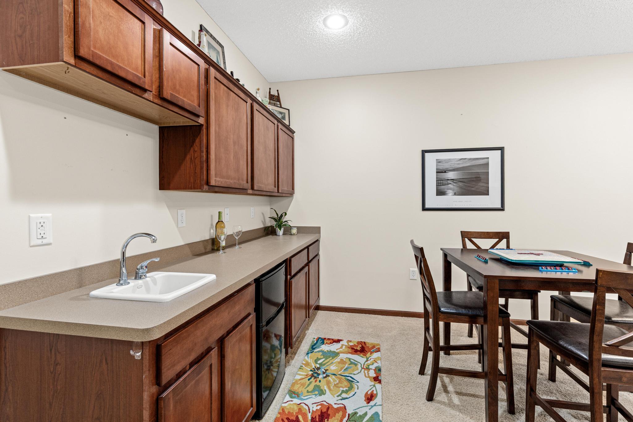 A convenient kitchenette with sink and mini-refrigerator supports gatherings, game nights, overnight guests or even multi-generational living.