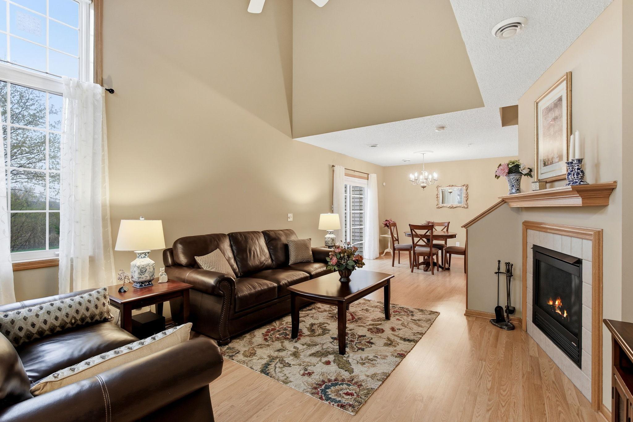 Upon entry, the living room opens up to a vaulted ceiling that creates a bright, airy feel, while two large corner windows flood the space with natural light.