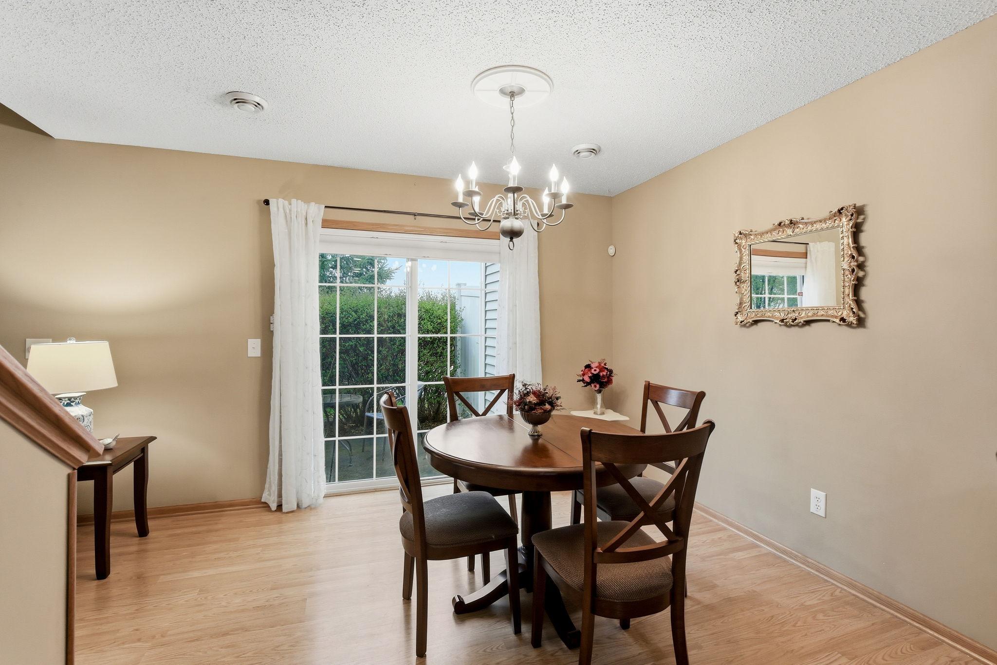 The dining room features a sliding glass door that opens directly onto the patio, providing easy access to outdoor relaxation.