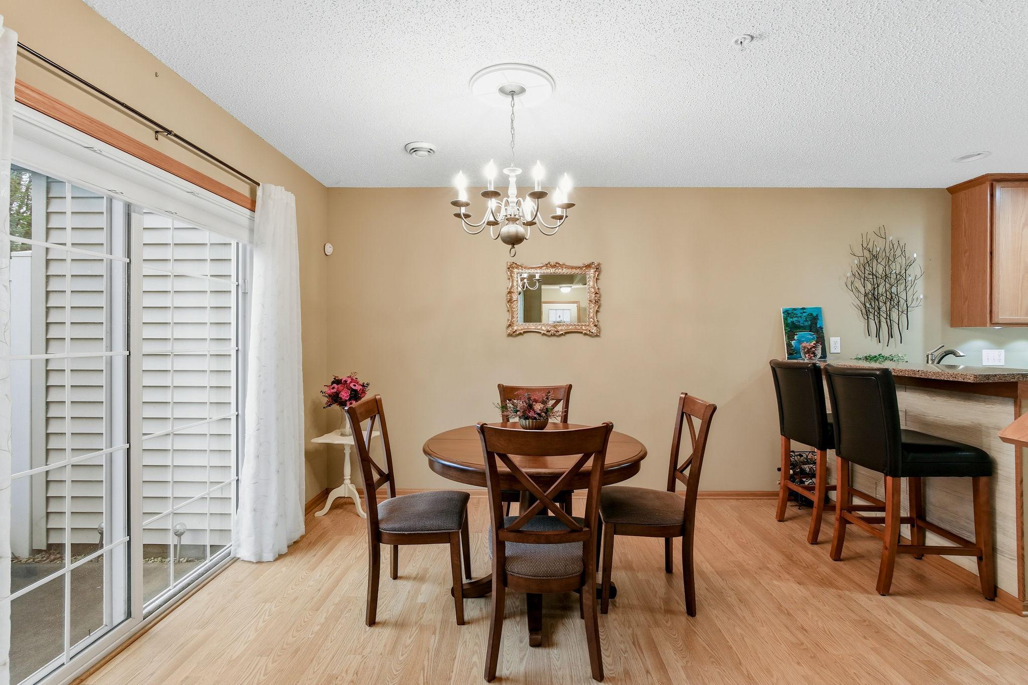 The dining room features an elegant light fixture and offers direct access to the patio, perfect for indoor-outdoor dining and entertaining.