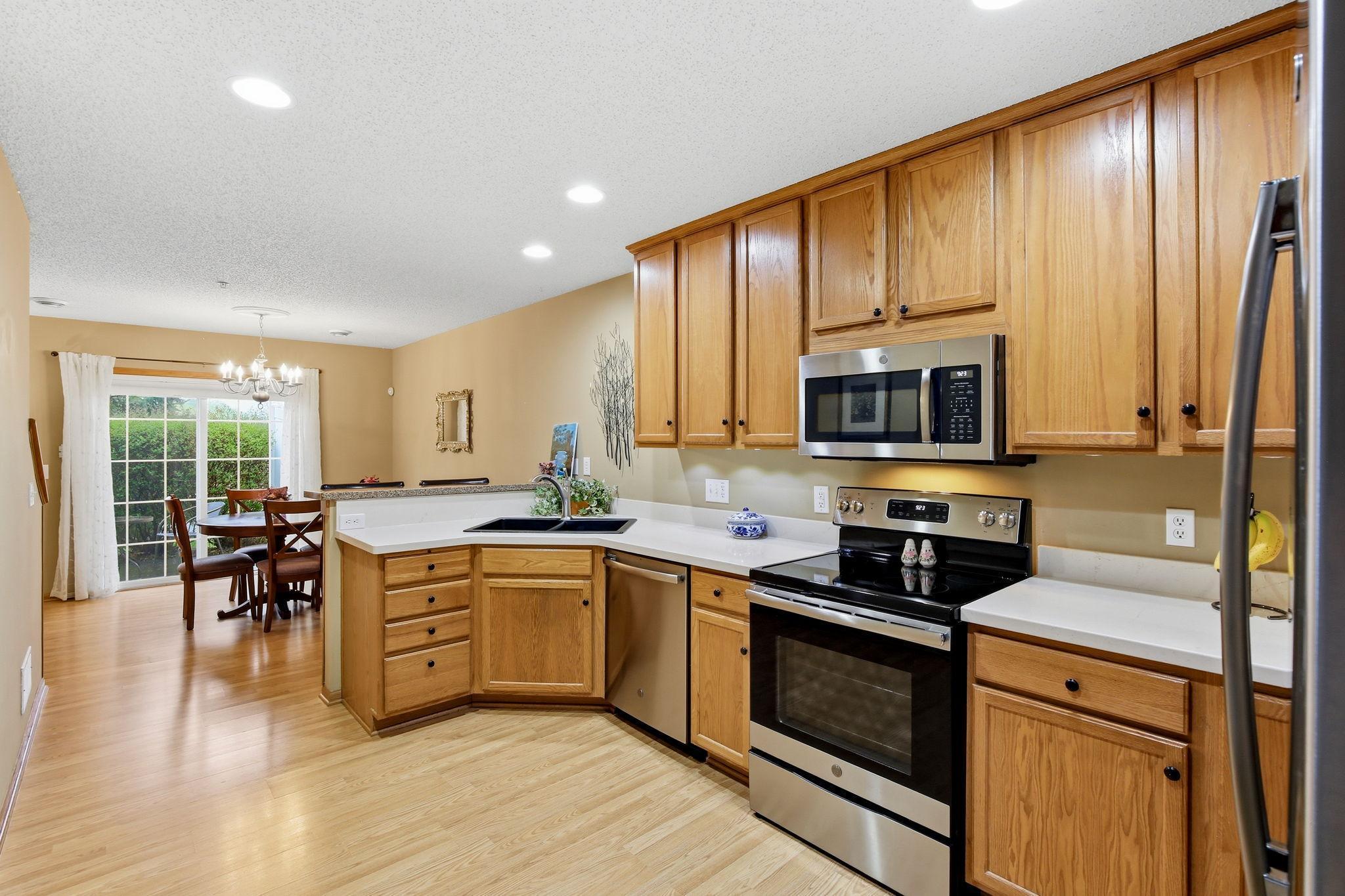 The kitchen highlights plenty of cupboards and ample counter space, offering both storage for everyday use.