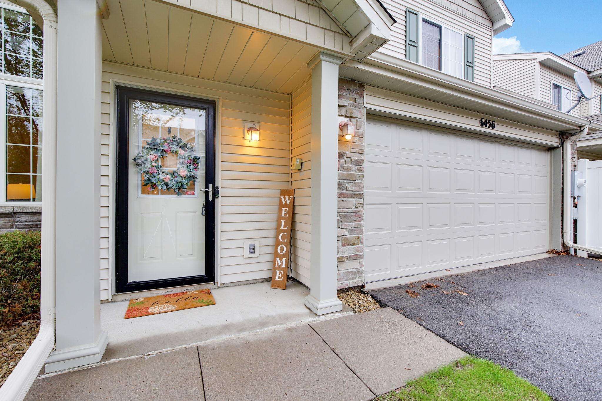 The front door is sheltered by a covered entry, providing protection from the elements and adding a cozy, welcoming touch to the home’s exterior.
