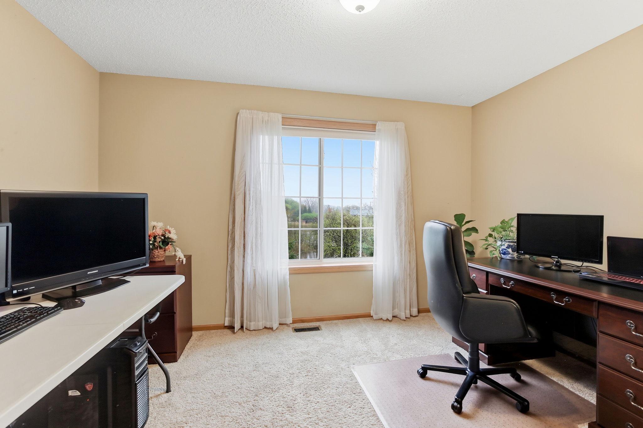 The third bedroom is currently used as an office and offers a generous layout, comfortably accommodating two desks.