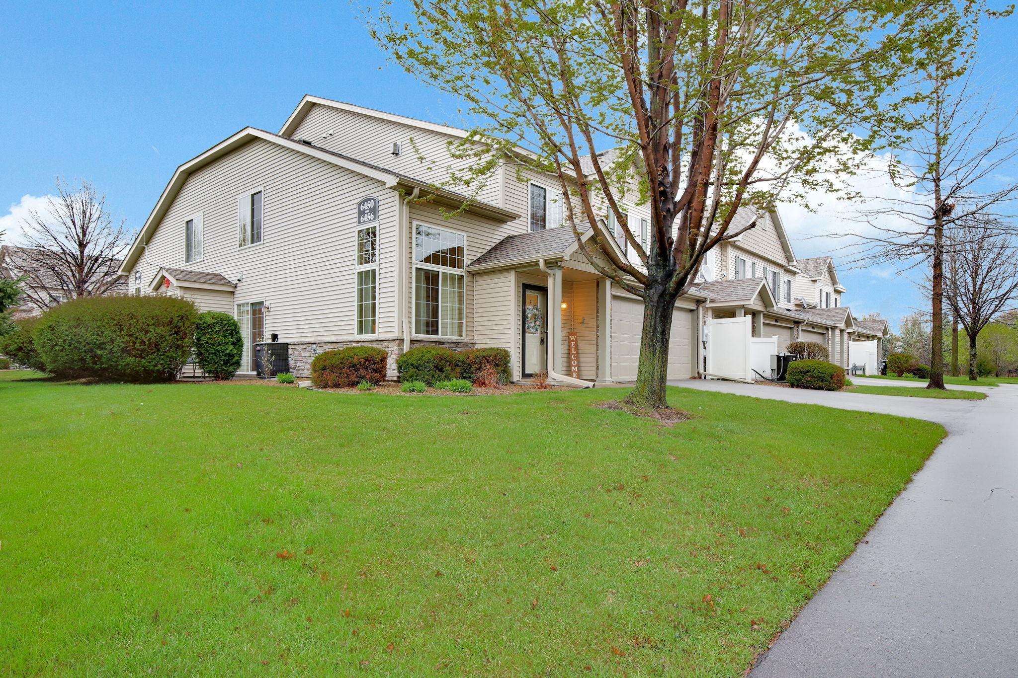 End unit offering additional space and beautiful landscaping, providing enhanced privacy and a welcoming outdoor setting.