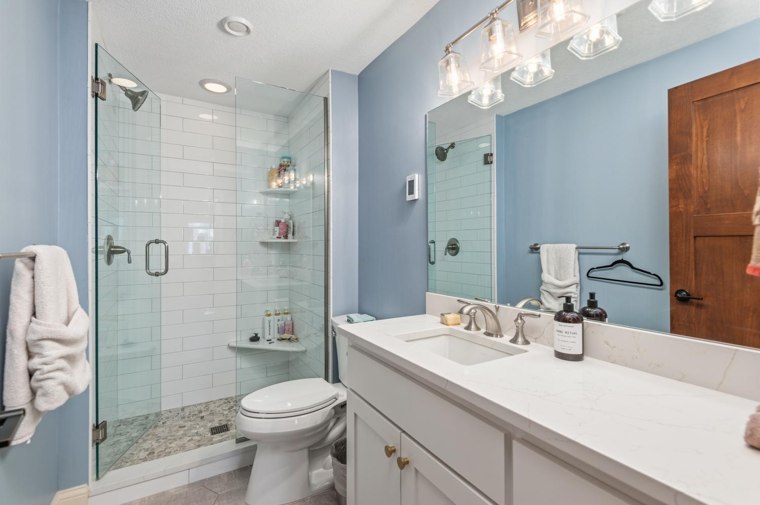Off the hallway in the lower level you will discover this beautifully remodeled three quarter bath.