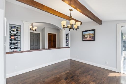 The dining room features plank floors, beams on the ceiling and a great view of the lake.