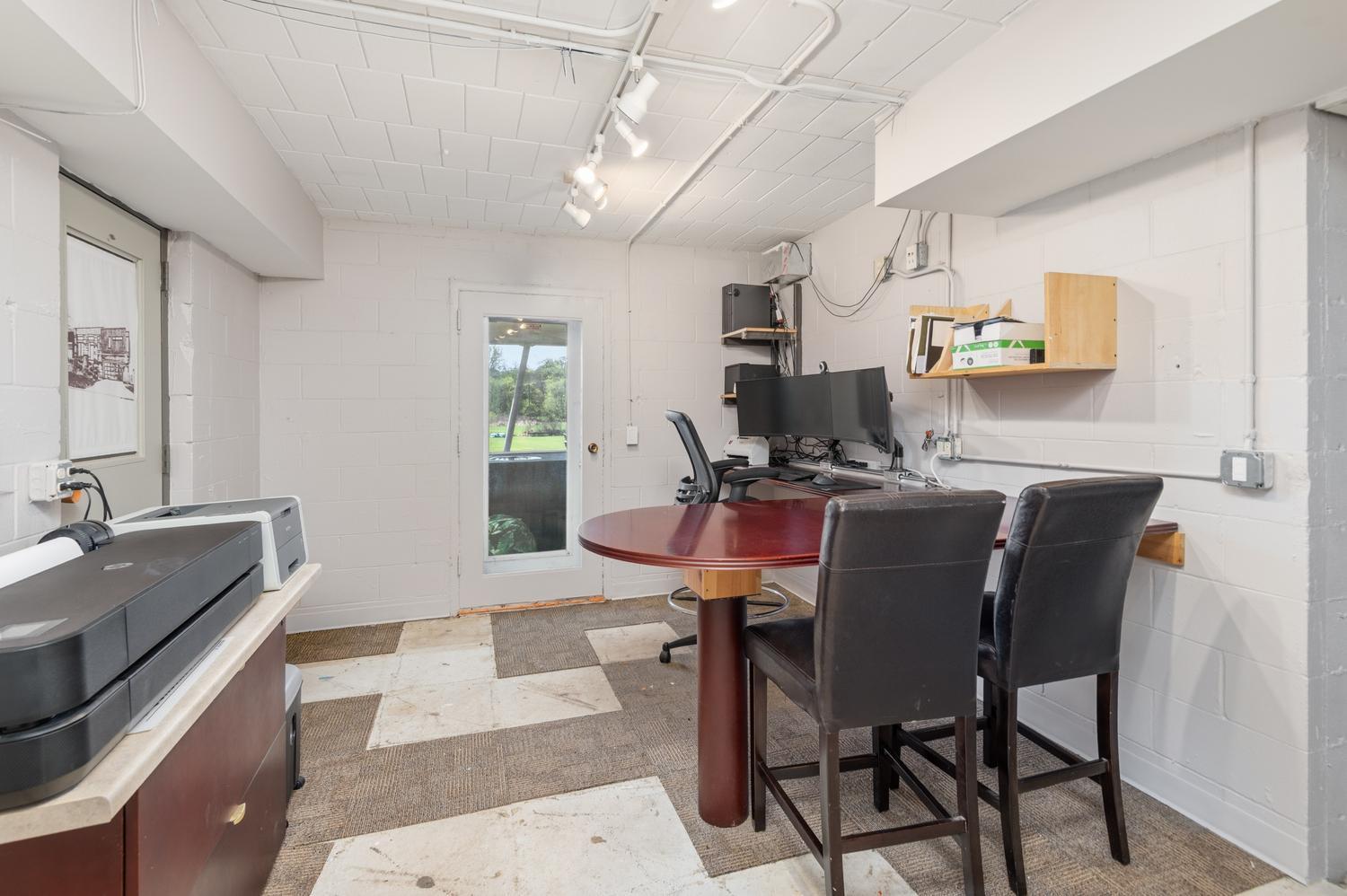 There is a secret door that steps into this office and the lower garage. There is a door to the back yard patio.