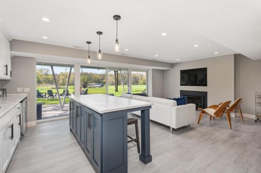 The center island offers great cabinet space and a place for guests to sit and relax. The family room tile floor is heated!