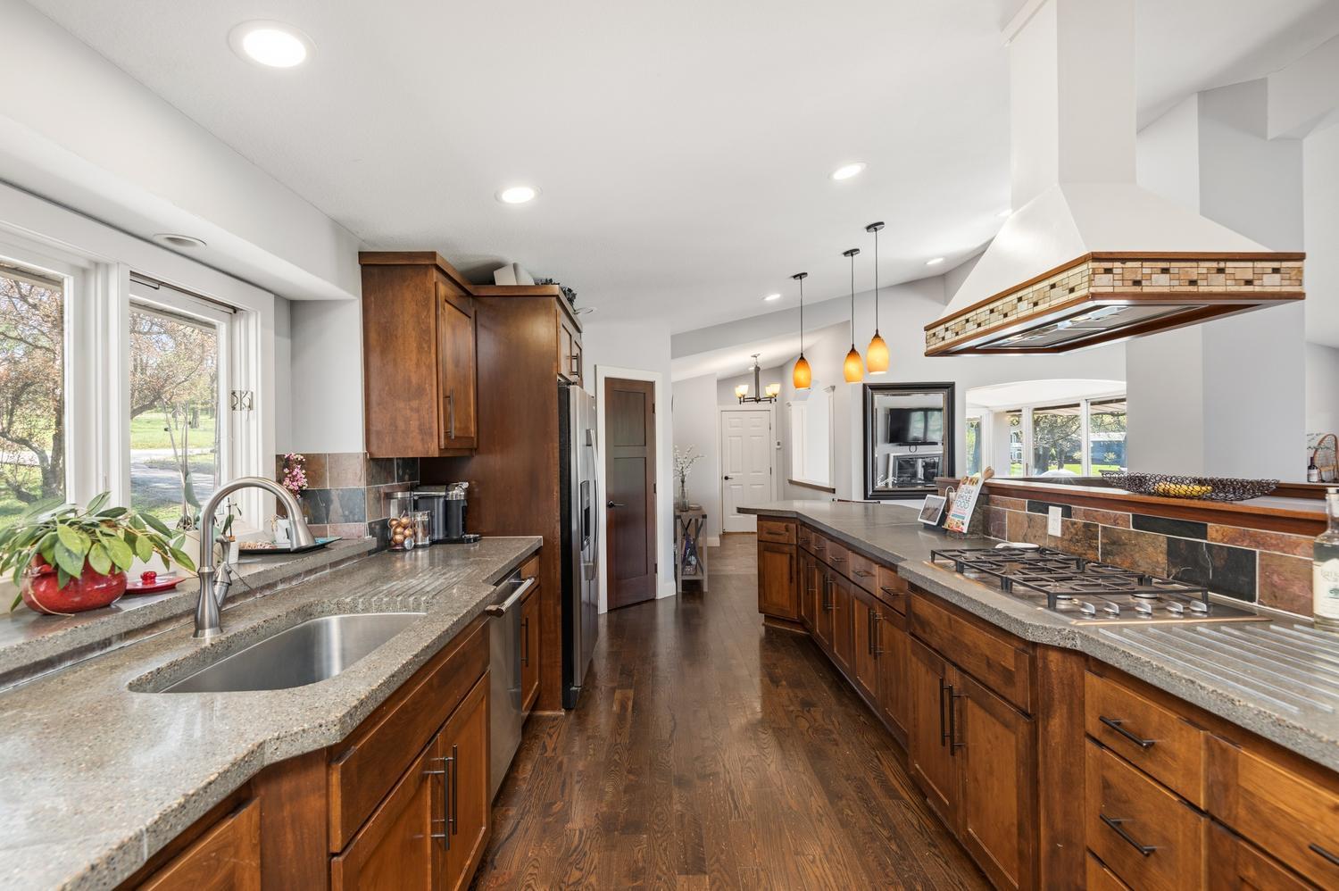 Appliances include a double oven, built in microwave, Fisher Paykel cook top with hood and Thermador dishwasher.