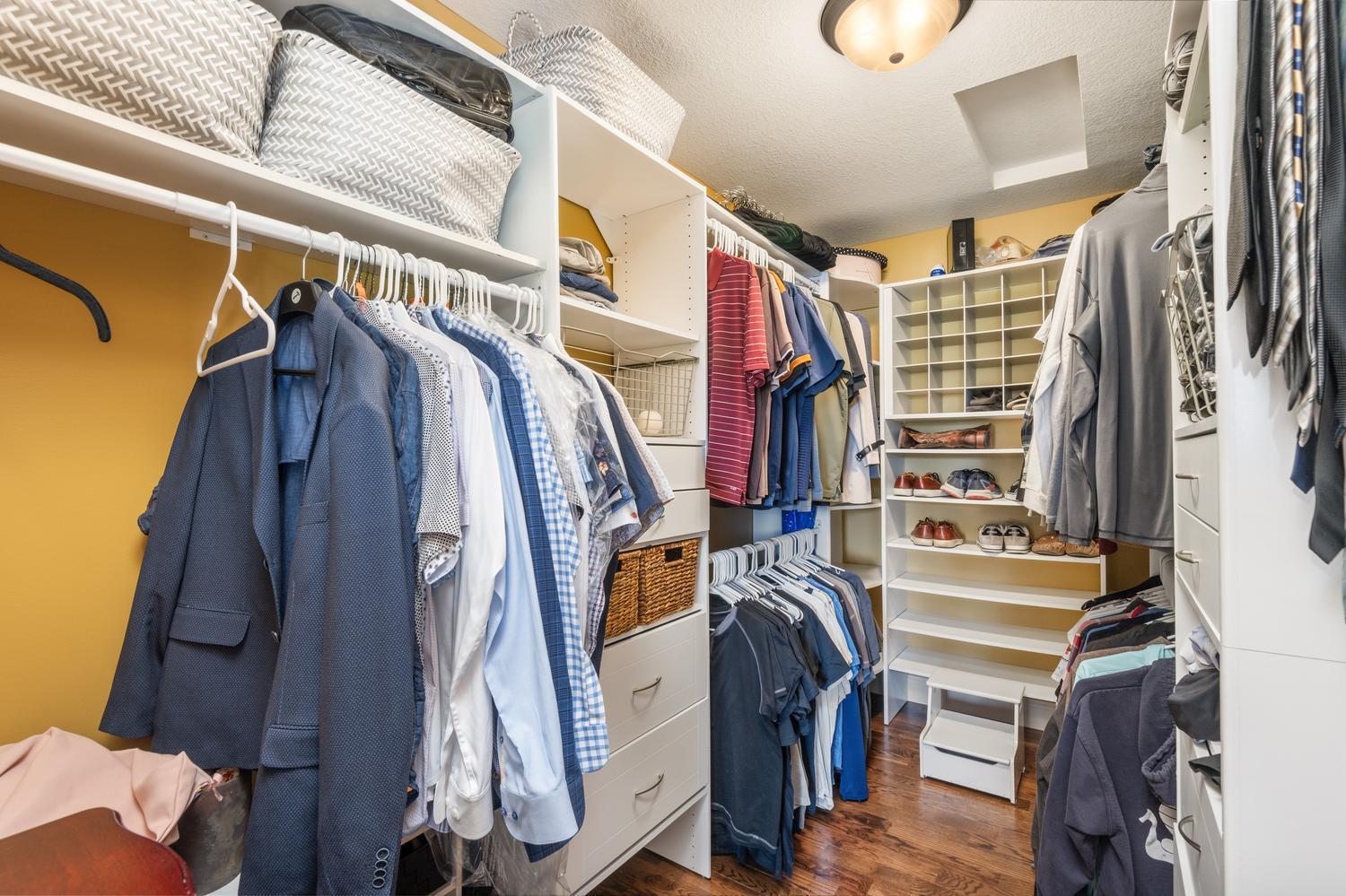 Very large walk in closet with closet organizers in the primary bedroom.