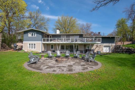 The one acre lot is wonderful, level lakeshore. Entertain at the premium patio and this circular paver patio with firepit.