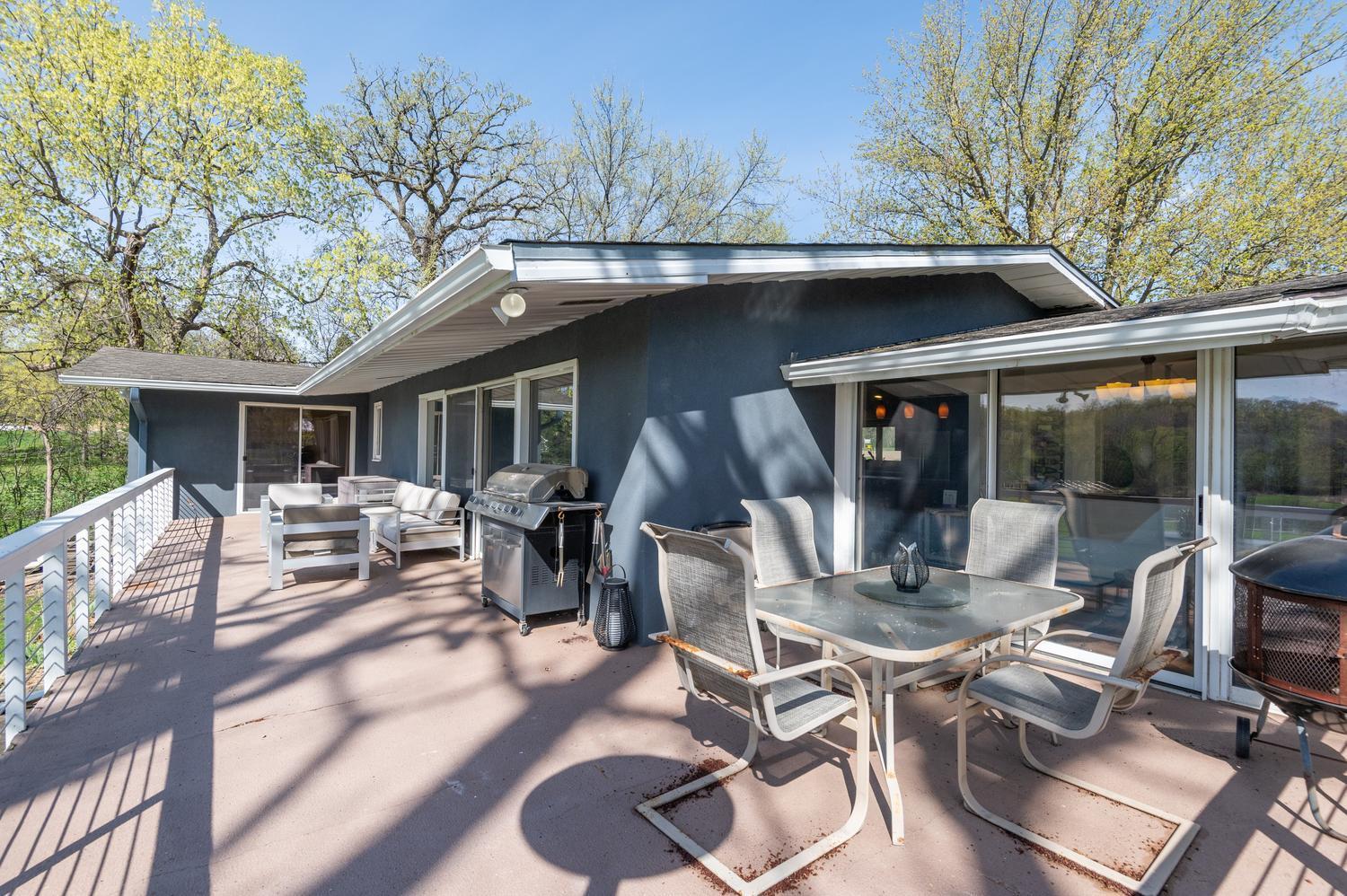 The large deck provides space for grilling, lounging and a dining table.