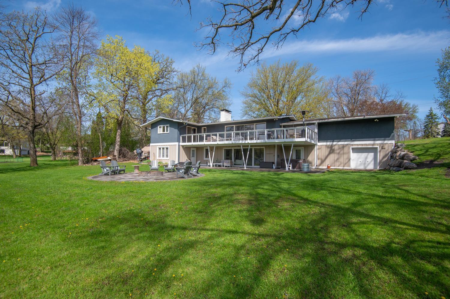 Fantastic level yard for kids to play and pets to run. There is a lower garage door and extra parking on the west end of the home too.