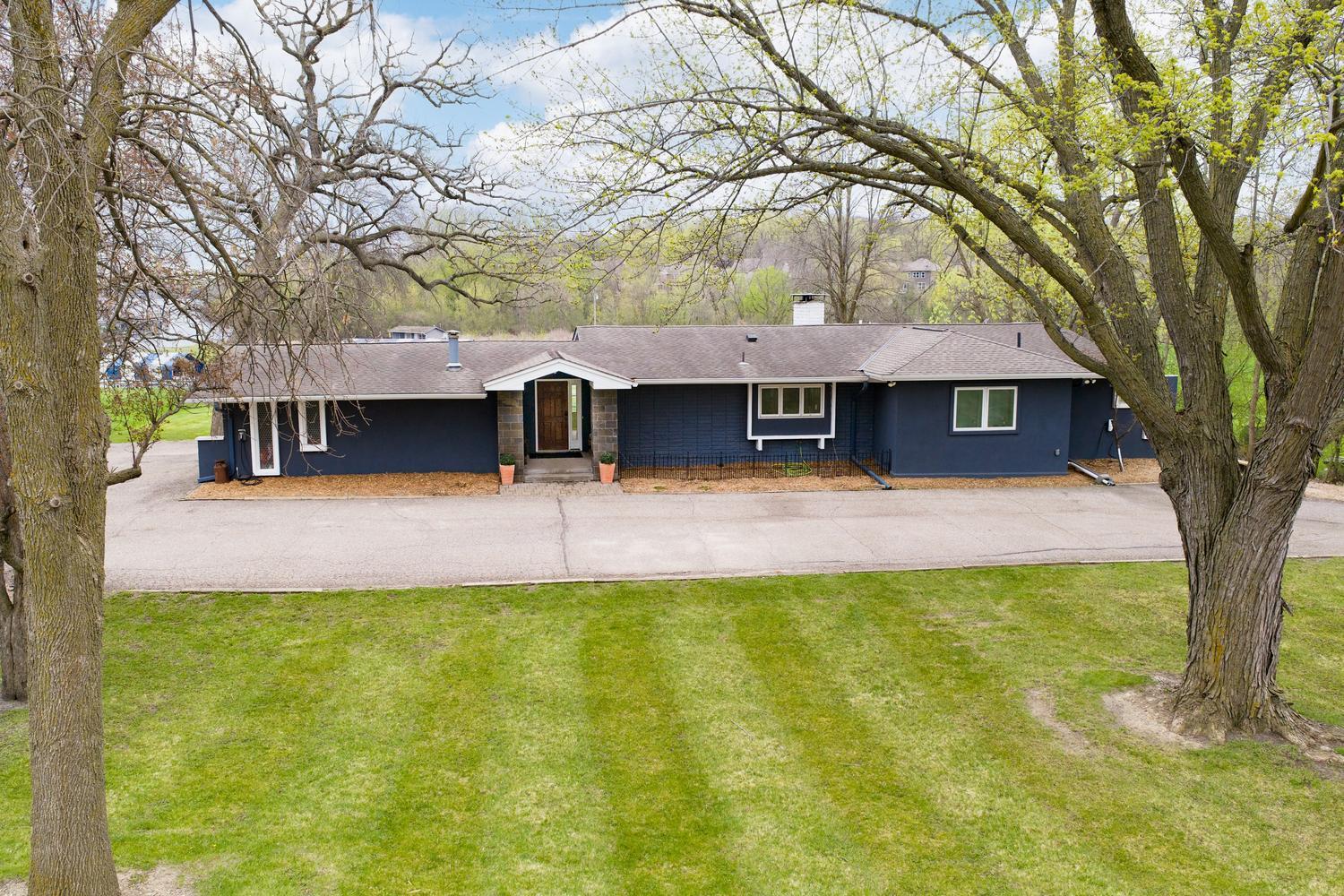 Large front yard with horseshoe driveway for guests to park.