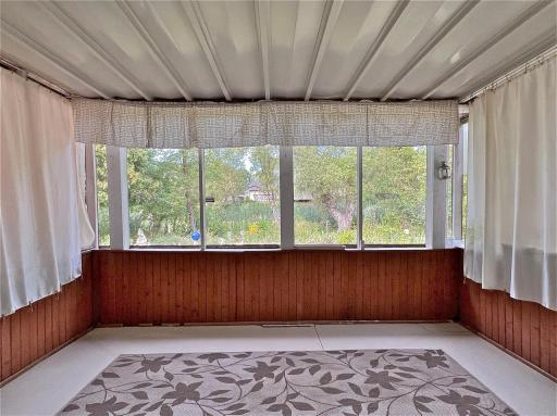 Enclosed back porch on the walkout lower level facing gardens