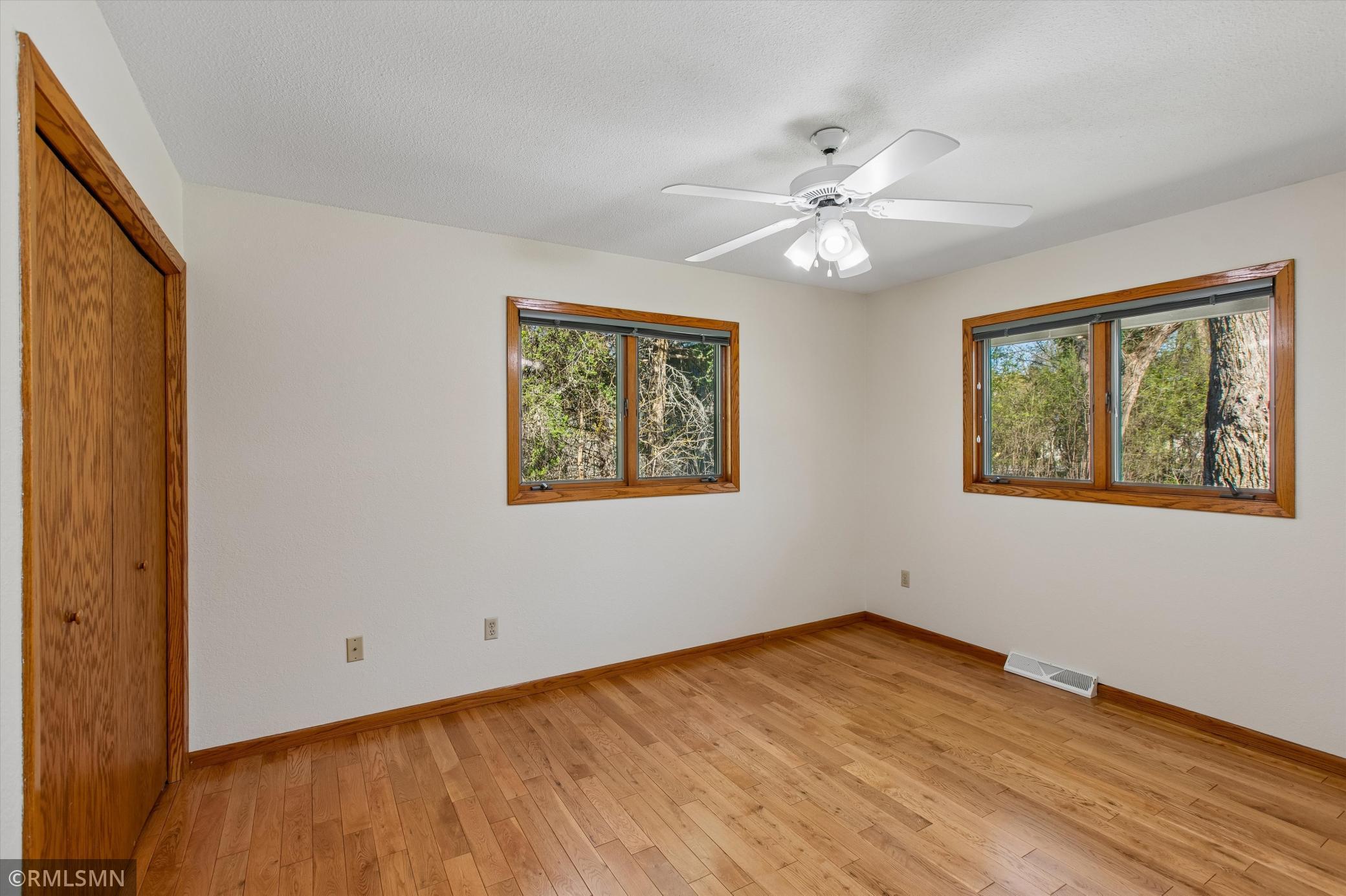 2nd bedroom on the main level has oak wood flooring. Could be a bedroom or office!